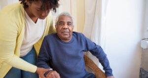 Caregiver helping an elderly man with home care in Calgary